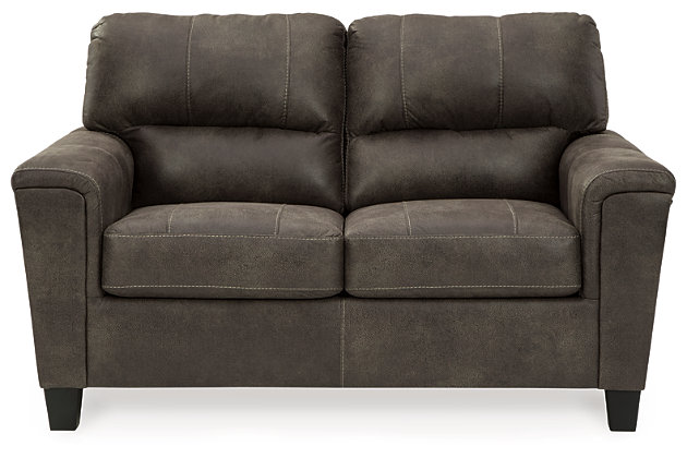 If you love the cool look of leather but long for the warm feel of fabric, you can take comfort in the Navi loveseat. Wrapped in a fabulous faux leather with a weathered hue and hint of pebbly texture to resemble the real deal, this decidedly modern loveseat proves less is more. Elements include angled side profiling and track armrests wrapped with a layer of pillowy softness for that little something extra. Prominent jumbo stitching and clean-lined divided back styling lend fashion-forward flair.Corner-blocked frame | Attached back and loose seat cushions | High-resiliency foam cushions wrapped in thick poly fiber | Polyester and polyurethane (faux leather) upholstery | Exposed feet with faux wood finish | Platform foundation system resists sagging 3x better than spring system after 20,000 testing cycles by providing more even support | Smooth platform foundation maintains tight, wrinkle-free look without dips or sags that can occur over time with sinuous spring foundations