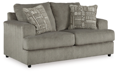 Flaunting a trendsetting silhouette, the Soletren loveseat puts the contemporary in your contemporary home. Its “three over two” profile eliminates the center seat cushion, giving you elongated plushness and deep seating. Microfiber fabric satisfies your need for a piece that feels as good as it looks. Accented with soft jacquard chenille throw pillows for a splash of geometric pattern and color contrast.Corner-blocked frame | Attached back and loose seat cushions | High-resiliency foam cushions wrapped in thick poly fiber | Platform foundation system resists sagging 3x better than spring system after 20,000 testing cycles by providing more even support | Smooth platform foundation maintains tight, wrinkle-free look without dips or sags that can occur over time with sinuous spring foundations | 2 decorative pillows included | Pillows with soft polyfill | Polyester upholstery and polyester pillows | Exposed feet with faux wood finish