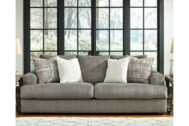Flaunting a trendsetting silhouette, the Soletren sofa puts the contemporary in your contemporary home. Its “three over two” profile eliminates the center seat cushion, giving you elongated plushness and deep seating. Microfiber fabric satisfies your need for a piece that feels as good as it looks. Accented with soft jacquard chenille throw pillows for a splash of geometric pattern and color contrast.Corner-blocked frame | Attached back and loose seat cushions | High-resiliency foam cushions wrapped in thick poly fiber | Platform foundation system resists sagging 3x better than spring system after 20,000 testing cycles by providing more even support | Smooth platform foundation maintains tight, wrinkle-free look without dips or sags that can occur over time with sinuous spring foundations | 4 decorative pillows included | Pillows with soft polyfill | Polyester upholstery and polyester pillows | Exposed feet with faux wood finish