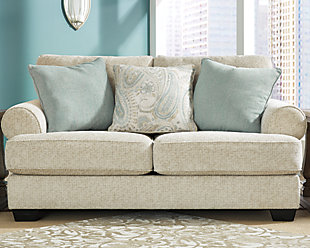 The Monaghan loveseat strikes a beautiful balance between classic and current. Traditional elements include t-cushion seating and setback roll arms, angled for modern flair. Posh collection of pillows in spa mist and jacquard paisley make a muted, mellow complement to the loveseat’s casual textured chenille upholstery. Choice of sandstone beige is a light and lovely style awakening.Plush seating | Corner-blocked frame | Reversible cushions | High-resiliency foam cushions wrapped in thick poly fiber | Platform foundation system resists sagging 3x better than spring system after 20,000 testing cycles by providing more even support | Smooth platform foundation maintains tight, wrinkle-free look without dips or sags that can occur over time with sinuous spring foundations | 3 toss pillows included | Pillows with soft polyfill | Polyester upholstery; polyester and polyester/linen pillows | Exposed feet with faux wood finish
