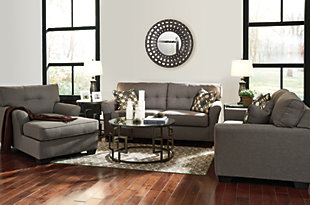 Make a high-style statement with this living room set. Inspired by high-end menswear, the Tibbee loveseat and sofa are tailored to perfection. Button-less tufting on the back cushions is richly subtle. Sleek, flared armrests enhance the clean-lined, simply striking profile. This seating arrangement is accompanied by a 3-piece coffee table set that takes a cool twist on contemporary style. Drum form metal bases sport a graphic keyway design that’s so striking. Clear glass tabletops naturally enhance the open and airy mood.Includes sofa, loveseat, coffee table and 2 end tables | Corner-blocked frame | Attached back and loose seat cushions | High-resiliency foam cushions wrapped in thick poly fiber | Toss pillows included | Pillows with soft polyfill | Polyester upholstery and pillows | Exposed feet with faux wood finish | Tables made of tubular metal and clear tempered glass; bronze-tone base finish | Tables require assembly  | Estimated Assembly Time: 45 Minutes