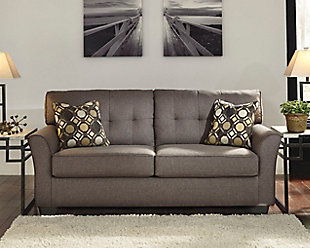 Inspired by high-end menswear, the Tibbee sofa is tailored to perfection and dressed to impress. Button-less tufting on the back cushions is richly subtle. Sleek, flared armrests enhance Tibbee’s clean-lined, simply striking profile.Corner-blocked frame | Attached back and loose seat cushions | High-resiliency foam cushions wrapped in thick poly fiber | 2 toss pillows included | Pillows with soft polyfill | Polyester upholstery and pillows | Exposed feet with faux wood finish