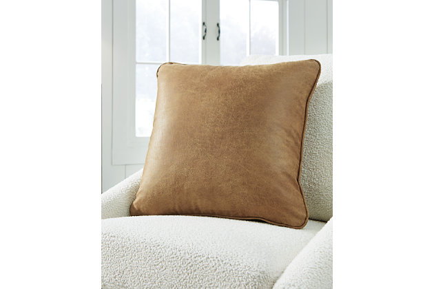In bomber-jacket brown this faux leather pillow conveys the easy poise of urban cool. Toss the Cortnie pillow in your living room or bedroom and add an air of nonchalant success to your home.Polyester cover | Welted edge construction | Zipper closure | Soft polyfill | Spot clean only | Imported
