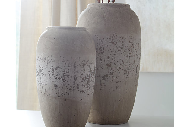 Is your home curated rather than simply decorated? Add another thoughtful piece into the mix with the Dimitra 2-piece vase set. Brown and antique cream painted ceramic has a unique weatherworn finish. Add fresh florals for a vintage-inspired look.Includes 2 vases (small and large) | Made of painted ceramic | Clean with a soft, dry cloth
