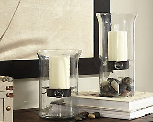 Delighting with a floating-on-air quality, Kadeem candle holders elevate your style in a revealing way. Clear glass design with removable candle trays allows you to incorporate stones, sand, pebbles or topiary touches to the base for an earthy element.Made of clear glass and metal | Clean with a soft, dry cloth | Holds pillar candles (not included) | Imported