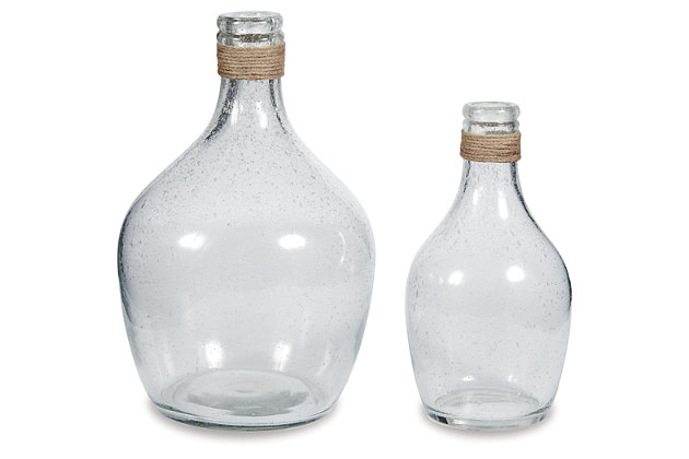 The Marcin 2-piece vase set’s versatility is a stylist’s dream. Light brown rope ties around the top of the bottleneck design. Seeded finish brings texture to the clear glass. Drop in faux cotton stems for a vintage or modern farmhouse look.Set of 2 | Made of glass and rope | Clean with a soft, dry cloth