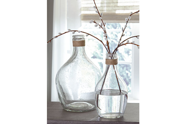 The Marcin 2-piece vase set’s versatility is a stylist’s dream. Light brown rope ties around the top of the bottleneck design. Seeded finish brings texture to the clear glass. Drop in faux cotton stems for a vintage or modern farmhouse look.Set of 2 | Made of glass and rope | Clean with a soft, dry cloth