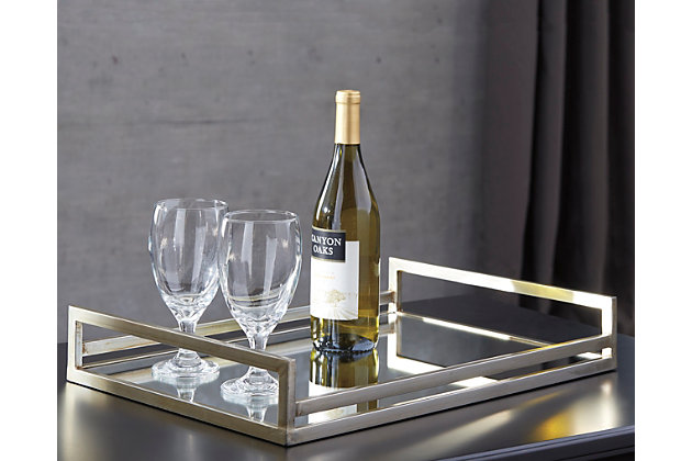 Corral magazines on the coffee table, house cosmetics on a vanity or simply serve a stylish breakfast in bed. No matter how it’s used, Derex mirrored glass tray delivers fabulous form with fantastic function.Made of metal with champagne-finish | Mirrored glass bottom | Clean with a soft, dry cloth