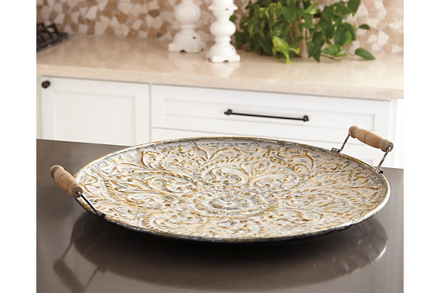 Heirloom-quality elegance that’s sized to make a statement. Didina tray’s embossed metal design is brought to life with the addition of a weathered goldtone finish. Top with carefully curated accent pieces or put on full display by propping against a wall.Made of metal with antiqued goldtone finish | Wood handles | Clean with a soft, dry cloth