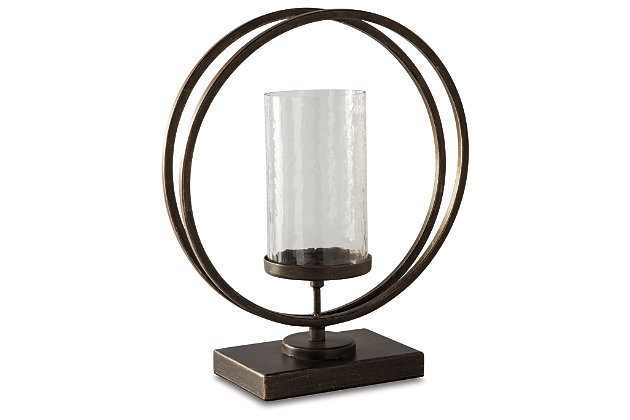 Add a splash of dimension with the Jalal candle holder. Grounded in an antiqued goldtone base, the waved glass is clearly a step above. It's the perfect addition to your eclectic collection.Holds one 3 to 4" pillar candle (not included) | Made of metal and glass | Clean with a soft, dry cloth