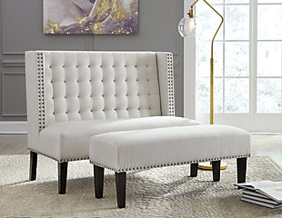 The Beauland settee boasts couture-inspired detailing with modern allure. Tufted wingback design is elevated with silvertone nailhead trim. Its luxe appeal with feel-good oatmeal colored fabric puts comfort in style.Made of wood | Polyester upholstery | Foam cushioned seat | Button tufting | Exposed legs with faux wood finish | Estimated Assembly Time: 30 Minutes