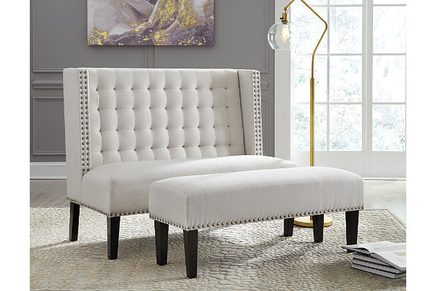 The Beauland settee boasts couture-inspired detailing with modern allure. Tufted wingback design is elevated with silvertone nailhead trim. Its luxe appeal with feel-good oatmeal colored fabric puts comfort in style.Made of wood | Polyester upholstery | Foam cushioned seat | Button tufting | Exposed legs with faux wood finish | Estimated Assembly Time: 30 Minutes