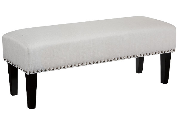 The Beauland accent bench boasts couture-inspired detailing with modern allure. Refined design is elevated with bronze-tone nailhead trim. Its luxe appeal with feel-good oatmeal colored fabric puts comfort in style.Made of wood | Polyester upholstery | Foam cushioned seat | Exposed legs with faux wood finish | Estimated Assembly Time: 15 Minutes