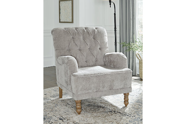 Give your classic style a modern edge with the Dinara accent chair. The diamond tufted back and dove gray color combine to create an elevated piece that pays homage to time-honored design while remaining entirely current.Polyester upholstery | Diamond tufted back | High-resiliency foam cushions wrapped in thick poly fiber | Attached back and t-seat cushion | Turned wood legs in light brown finish | Platform foundation system resists sagging 3x better than spring system after 20,000 testing cycles by providing more even support | Smooth platform foundation maintains tight, wrinkle-free look without dips or sags that can occur over time with sinuous spring foundations | Estimated Assembly Time: 15 Minutes