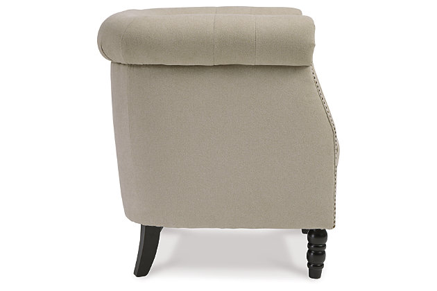 Bring a European style to your home with the Jacquelyne accent chair. The soft beige color is sophisticated and subtle while the tufted barrel back and turned wood legs evoke an air of exclusivity. Make your space your own private club with this uptown piece.Button tufted barrel back | Attached seat cushion with spring construction | Foam cushions wrapped in thick poly fiber | Soft beige polyester upholstery | Nailhead detail | Wood turned legs in black finish | Estimated Assembly Time: 15 Minutes