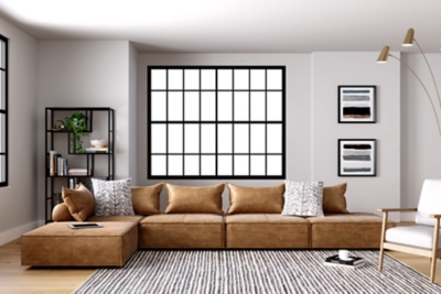 Deep, low seating says relax. Covered on all sides in a sleek and modern distressed faux leather with welted edges, the Bales accent chair set can be easily rearranged in infinite configurations. Thanks to its modular design, making the transformation from sectional to conversation pit is practically effortless.Includes 5 modular accent chairs | Distressed brown faux leather upholstery | 5 welted pillows and 5 bolsters with non-slip decking | Plastic non-slip feet in black finish | Minimal assembly required | Estimated Assembly Time: 75 Minutes