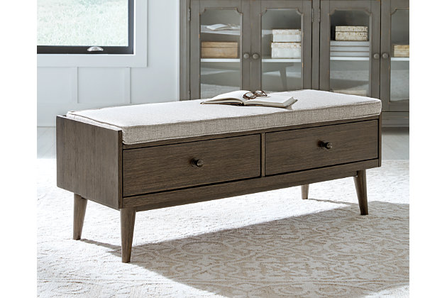 Style gets a practical upgrade with the two drawers of the Chetfield bench. The warm brown finish topped with a reversible cushion upholstered in gray fabric works in so many decor styles. Finished off with tapered legs and black-finish metal drawer pulls, this piece adds an efficient charm to your home.Made of veneer, solid and engineered wood and polyester | Wood frame in brown finish | Black metal drawer pulls | 2 drawers | Reversible cushion upholstered in gray polyester fabric | Assembly required | Estimated Assembly Time: 15 Minutes