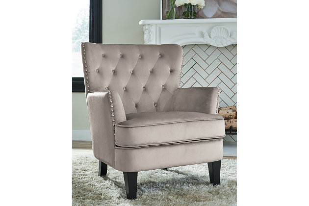 Don't leave your living room incomplete. Fill the open space with the Romansque accent chair. Slim track arms and nailhead trim give this traditional silhouette an updated and inviting appeal. The diamond tufted back cushion and attached seat cushion are an absolute pleasure to sit in. Alone or paired with other upholstery, this chair is a class act.Beige polyester velvet upholstery | Diamond tufted back | Attached seat cushion | Bronze finished nailhead trim | Wood legs in black finish | Minimal assembly required | Estimated Assembly Time: 15 Minutes