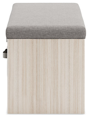 Sit and store in style. Blariden storage bench is topped with a cool gray cushion for a soft touch. Its removable fabric baskets are perfect for storing cold-weather essentials or keeping clutter under wraps. A light tan finish cleanly completes the look. Works wonders in your child's bedroom or play space.Made with engineered wood and veneer | Gray polyester seat cushion | 2 open cubbies, each with fabric basket | Solid wood legs in dark brown finish | Assembly required | Estimated Assembly Time: 60 Minutes