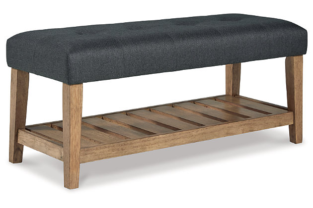 The solid construction and timeless style of the Cabellero bench make it the perfect accent piece in your living room, bedroom or entryway. A wood slat storage shelf and cushioned top add a sense of airy sophistication and charming rustic style.Solid wood in medium brown finish | Attached tufted seat cushion in charcoal polyester upholstery | Wood slat shelf | Assembly required | Estimated Assembly Time: 30 Minutes