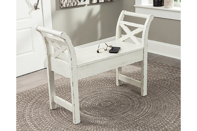 Do you have a soft spot for the classics? Well, you've just found your new favorite. Rough and smooth come together in the Heron Ridge bench, outfitted with vintage-inspired details like the classic “X” motif in a charming antique white. Cleverly designed with hidden storage space, this multi-functional piece is a fresh take on tried and true style.Made of veneers and solid wood | Antique white finish | Hinged top with underlying storage | Estimated Assembly Time: 30 Minutes