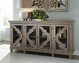 Wowing with exquisite quatrefoil framing, made all the more dramatic with the contrast of clear glass, the Fossil Ridge 4-door cabinet serves up an easy-elegant aesthetic sure to satisfy. The light and lovely finish brings a relaxed sensibility to the scene.Made of solid and engineered wood | Gray distressed finish | Black-finished metal hardware | 4 cabinet doors with glass inlays | 3 adjustable shelves | Excluded from promotional discounts and coupons | Estimated Assembly Time: 30 Minutes