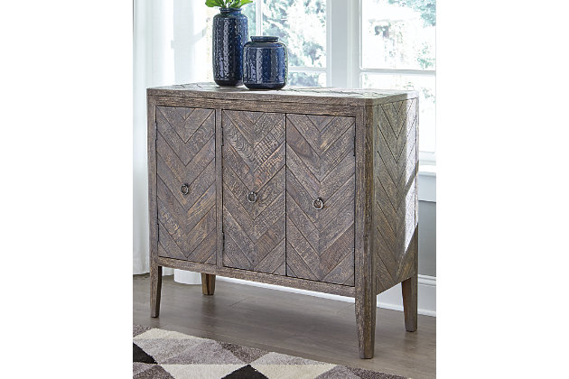 Rustic with a contemporary remix. The Boyerville accent cabinet adds extra storage to your home. Wood grain shows beautifully through the antiqued gray finish. Herringbone pattern elevates the aesthetic for an unmatched look. Round silvertone door pulls put the finishing touches on this stylish piece.Made of wood and engineered wood | Antiqued silvertone finished metal door pulls | 3 doors and 2 shelves | Estimated Assembly Time: 30 Minutes