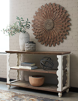 Simply put, the Alwyndale console sofa table is minimalism with maximum charm. Naturally finished knotty wood combined with antiqued white is an artful combination. But what really makes this console sofa table so spectacular: scalloped woodwork you just don’t see every day.Made of wood | Natural and antiqued white finishes | 2 fixed shelves | Estimated Assembly Time: 15 Minutes