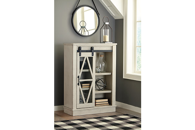 Put your love of modern farmhouse living on display with the Bronfield accent cabinet. Antique white finish and sliding "barn door" make it loaded with character. Four adjustable shelves are packed with potential.Made of wood and engineered wood | Black finished metal hardware | Sliding door with glass panel front | 4 adjustable shelves | Assembly required | Estimated Assembly Time: 30 Minutes