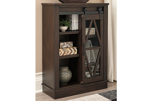 Put your love of modern farmhouse living on display with the Bronfield accent cabinet. Rich brown finish and sliding "barn door" make it loaded with character. Four adjustable shelves are packed with potential.Made of wood and engineered wood | Black finished metal hardware | Sliding door with glass panel front | 4 adjustable shelves | Assembly required | Estimated Assembly Time: 30 Minutes