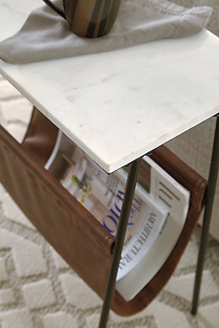 With its mixed media design, the Etanbury accent table with magazine holder is what’s new—and what’s you. Fusion of black metal, white marble and brown faux leather creates a contemporary aesthetic that’s the genuine article.Made of metal in black finish | White marble tabletop | Brown faux leather magazine holder | Assembly required | Estimated Assembly Time: 15 Minutes