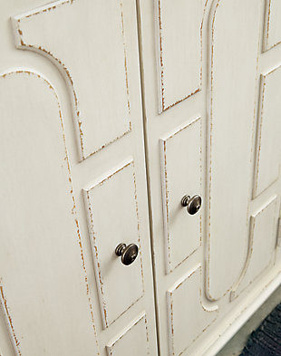 Whether your style is cottage chic, boho inspired or uniquely eclectic, the Roranville accent cabinet is sure to look right at home. Standout elements include raised panel door fronts that are a work of art. Wonderfully timeworn in antique white, this 4-door cabinet is topped with a warm brown finish for two-tone interest. Two adjustable shelves add to its practicality.Made of veneer, wood and engineered wood | Antique white and brown finish | 4 doors | 2 adjustable shelves | Bronze-tone metal door pulls | Assembly required | Estimated Assembly Time: 45 Minutes