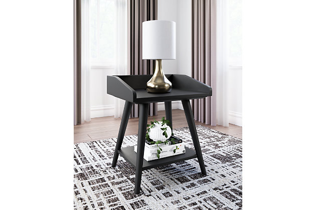 Display decor with simple style on the Blariden accent table. Constructed of wood and engineered wood in a dark metallic gray finish, this table blends easily with your existing living room aesthetic or stands in as a kid's bedside table. A gallery rail top, undermount shelf and dual USB chargers keep your life (and your look) simply sensational. Made of wood and engineered wood | Dark metallic gray finish | Gallery rail top | Fixed shelf | 2 USB charging ports; power cord included | Assembly required | Estimated Assembly Time: 30 Minutes