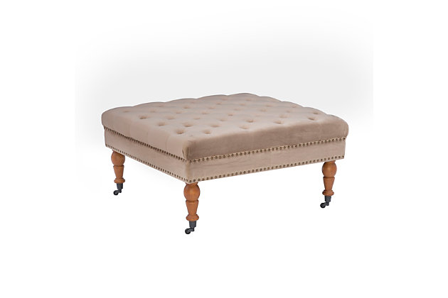 Square tufted ottoman on metal casters brings high style and versatility to your living space. Perfect as a footrest or coffee table, it wows with a tufted top and velvety soft tan fabric. Antiqued brass-tone nailheads accent the side, while turned dark walnut legs complete the richly traditional look.Made of birch wood | Foam cushioned seat covered in velvet polyester upholstery | Tufted top | Antiqued brass-tone nailhead trim | Dark walnut-tone finished legs | Metal casters | Assembly required