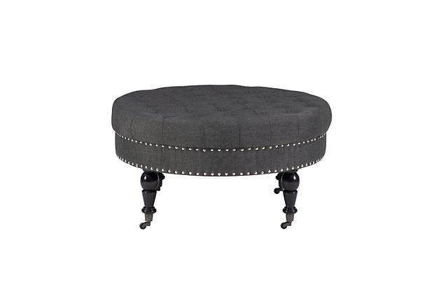 Round tufted ottoman on metal casters brings high style and versatility to your living space. Perfect as a footrest or coffee table, it wows with a tufted top and feel-good charcoal linen fabric. Silvertone nailheads accent the side, while turned black legs complete the richly traditional look.Made of birch wood | Foam cushioned seat covered in charcoal linen upholstery | Tufted top | Silvertone nailhead trim | Black finished legs | Metal casters | Assembly required