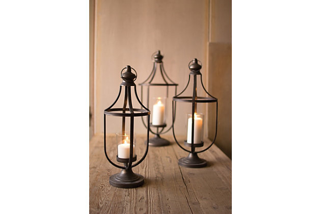 Delight in the beauty of this 3-piece lantern-style candle holder set. Whether enjoyed year-round or reserved for patio parties or holiday festivities, what an illuminating choice for an easy-elegant look.Set of 3 | Made of metal with glass inserts | Holds 3 pillar candles (not included) | For indoor use (or on covered porch or patio)