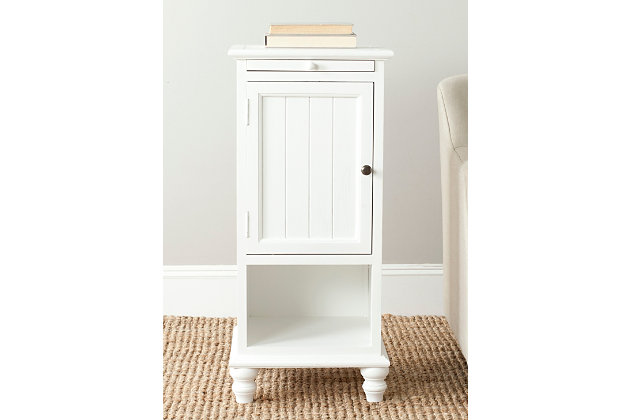 A quaint—and practical—accompaniment to country cottage and modern farmhouse interiors, this storage cabinet in crisp white is loaded with possibilities, from the family room to the guest bath. Charming beadboard-style cabinet reveals ample stowaway space. Open cubby makes whatnots so accessible, while pullout tray extends your surface space for everything from makeup to snacks and remote controls.Made of wood | White finish | Cabinet storage with shelf | Open cubby | Pull-out tray | No assembly required