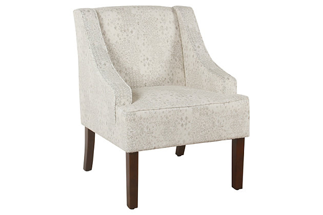 The graceful swoop-arm styling of this accent chair sets the tone for all proclaimed casually cool spaces. A rich wood finish, designer fabric and welted cushions perfect the laid-back vibe.Made of wood and engineered wood | Attached cushions | Medium firm foam and sinuous spring cushions | Woven cream and gray fabric upholstery with stencil pattern | Welted seams | Exposed legs with walnut finish | Assembly required