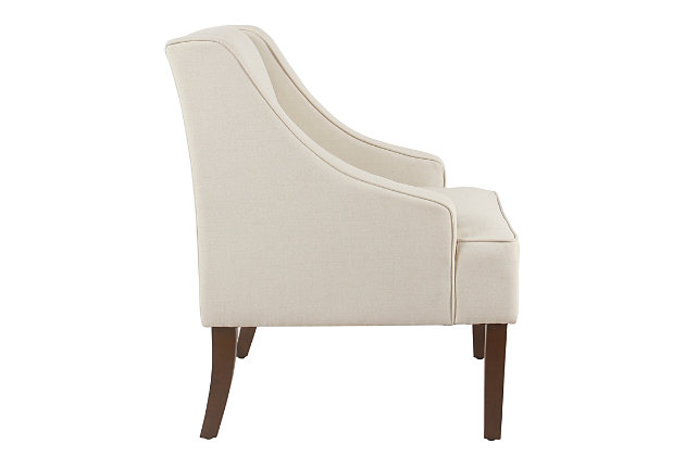 The graceful swoop-arm styling of this accent chair sets the tone for all proclaimed casually cool spaces. A rich wood finish, designer fabric and welted cushions perfect the laid-back vibe.Made of wood and engineered wood | Attached cushions | Medium firm foam and sinuous spring cushions | Woven textured cream fabric upholstery | Welted seams | Exposed legs with walnut finish | Assembly required