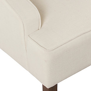 The graceful swoop-arm styling of this accent chair sets the tone for all proclaimed casually cool spaces. A rich wood finish, designer fabric and welted cushions perfect the laid-back vibe.Made of wood and engineered wood | Attached cushions |  firm foam and sinuous spring cushions | Woven textured cream fabric upholstery | Welted seams | Exposed legs with walnut finish | Assembly required