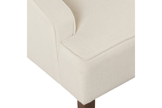 The graceful swoop-arm styling of this accent chair sets the tone for all proclaimed casually cool spaces. A rich wood finish, designer fabric and welted cushions perfect the laid-back vibe.Made of wood and engineered wood | Attached cushions |  firm foam and sinuous spring cushions | Woven textured cream fabric upholstery | Welted seams | Exposed legs with walnut finish | Assembly required