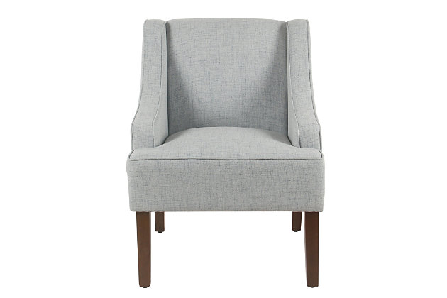 The graceful swoop-arm styling of this accent chair sets the tone for all proclaimed casually cool spaces. A rich wood finish, designer fabric and welted cushions perfect the laid-back vibe.Made of wood and engineered wood | Attached cushions | Medium firm foam and sinuous spring cushions | Woven textured light blue upholstery | Welted seams | Exposed legs with walnut finish | Assembly required