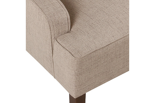 The graceful swoop-arm styling of this accent chair sets the tone for all proclaimed casually cool spaces. A rich wood finish, designer fabric and welted cushions perfect the laid-back vibe.Made of wood and engineered wood | Attached cushions | Medium firm foam and sinuous spring cushions | Woven tan linen-feel upholstery | Welted seams | Exposed legs with walnut finish | Assembly required