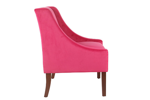 The graceful swoop-arm styling of this accent chair sets the tone for all proclaimed casually cool spaces. A rich wood finish, designer fabric and welted cushions perfect the laid-back vibe.Made of wood and engineered wood | Attached cushions | Medium firm foam and sinuous spring cushions | Deep pink velvet upholstery | Welted seams | Exposed legs with walnut finish | Assembly required