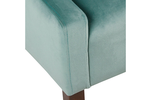 The graceful swoop-arm styling of this accent chair sets the tone for all proclaimed casually cool spaces. A rich wood finish, designer fabric and welted cushions perfect the laid-back vibe.Made of wood and engineered wood | Attached cushions | Medium firm foam and sinuous spring cushions | Light aqua velvet upholstery | Welted seams | Exposed legs with walnut finish | Assembly required