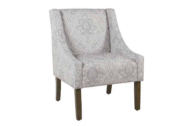 The graceful swoop-arm styling of this accent chair sets the tone for all proclaimed casually cool spaces. A rich wood finish, designer fabric and welted cushions perfect the laid-back vibe.Made of wood and engineered wood | Attached cushions | Medium firm foam and sinuous spring cushions | Woven gray and cream fabric upholstery with damask design | Welted seams | Exposed legs with walnut finish | Assembly required