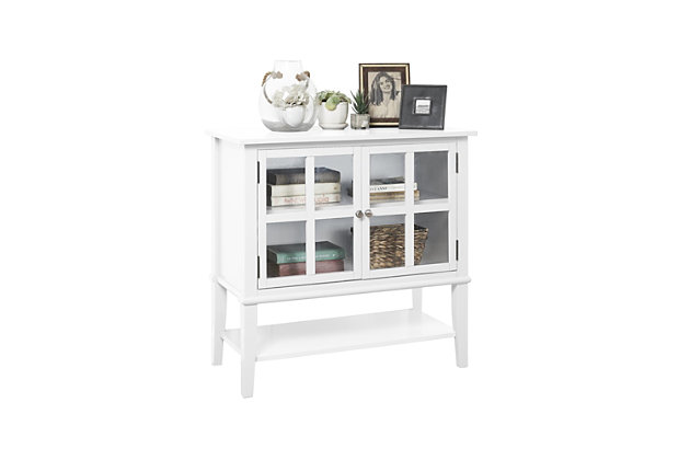 Master the art of organization in an entryway, main living area or home office with this highly versatile 2-door storage cabinet in white. Glass-front double doors with mullion frame reveal a roomy storage cabinet with adjustable shelving. Lower shelf makes this compact piece that much more accommodating.Made of wood and engineered wood | 2 doors with glass panels | Adjustable door hinges | Adjustable cabinet shelf; fixed lower shelf | Assembly required