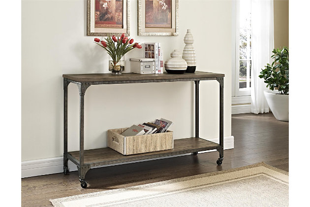 Roll out rustic industrial flair with this ultra-cool console table. Whether serving as a sofa table or taking center stage in the entryway, this accent table with locking casters offers so much versatility. Be it in a modern farmhouse or urban loft, this designer table with weathered charm simply says welcome home.Made of metal and wood veneer | Distressed finish | Tabletop and shelf with plank effect | Locking casters included | Assembly required