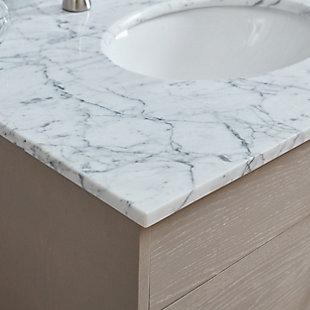 Invite a farmhouse feel into your bathroom with this charming vanity sink. The authentic Carrara marble countertop crafts a luxurious look, while spacious cabinet drawers ensure no toiletry gets left behind. Topped with white, gray-veined marble, this vanity gives your bath a light and airy feel and smooth, simple design. This elegant vanity sink inspires effortless yet rustic style and provides handy storage in any bathroom, powder room, or master suiteVanity cabinet with marble counter top and backsplash | Authentic Carrara marble countertop | 3 drawers and 1 faux drawer under sink | Pre-drilled for 8” wideset faucet | Estimated Assembly Time: 5 Minutes