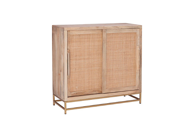 Simple and geometric, this sliding door cabinet offers versatile function without sacrificing distinctive style. The cabinet’s real wood caning and gleaming goldtone metal frame anchor your room with strong architectural lines. Blending elements from colonial and urban industrial decor, this cabinet complements any home or office in both form and function.Made of mango wood, wood cane rattan and metal | Natural finish | Goldtone metal base | Sliding door cabinet with 1 fixed shelf | No assembly required